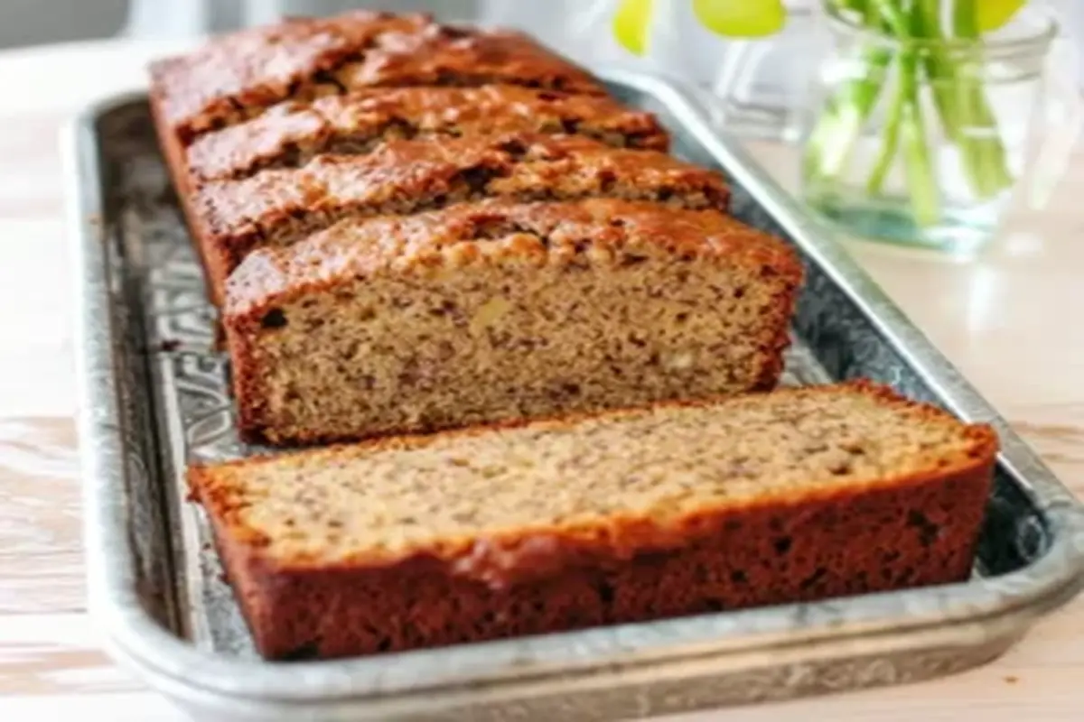 Sliced Chobani banana bread on a tray, showcasing its moist texture and golden-brown crust, perfect for a healthy baking recipe.